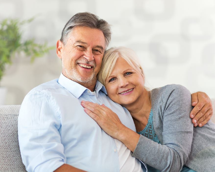 Older couple sitting together on a sofa